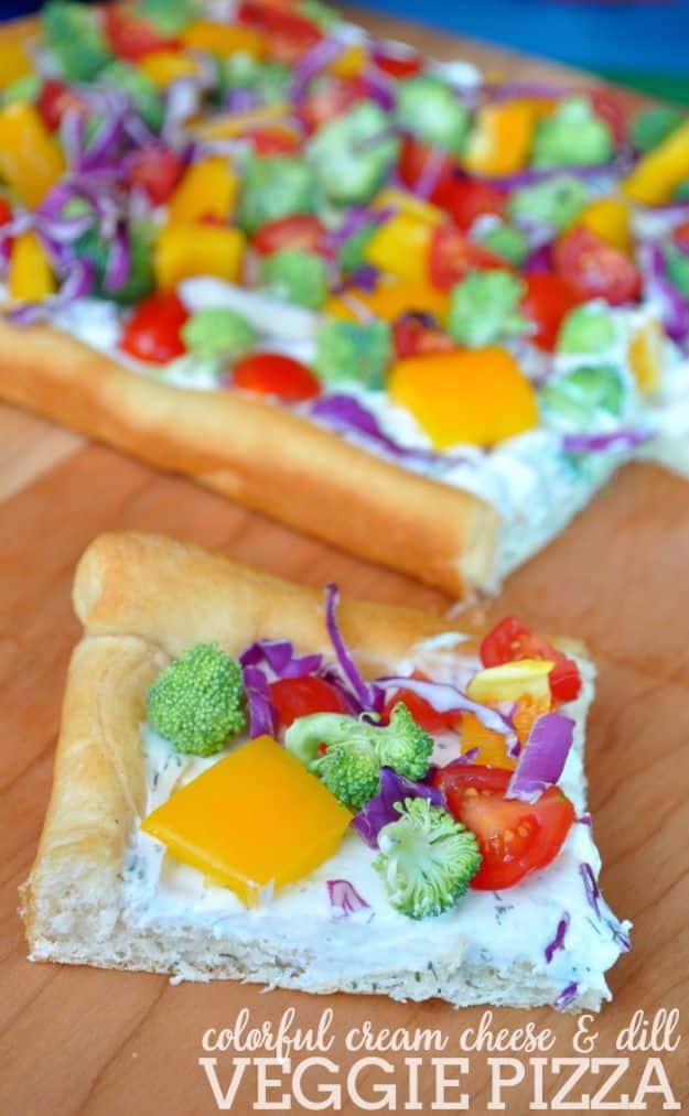 Cream cheese and dill veggie pizza on a crescent roll crust topped with broccoli, tomatoes and bell pepper