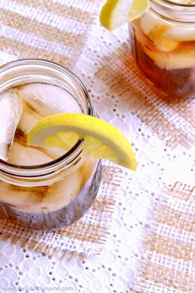 Striped painted burlap coasters with fringed edges under two mason jar iced teas on an outdoor table