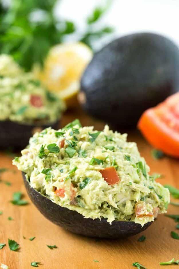 Tuna avocado boats, an avocado skin filled with chunky no mayo tuna salad flecked with tomato and parsley