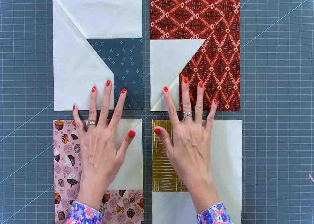 Laying out the quilt blocks to make the layer cake spools quilt