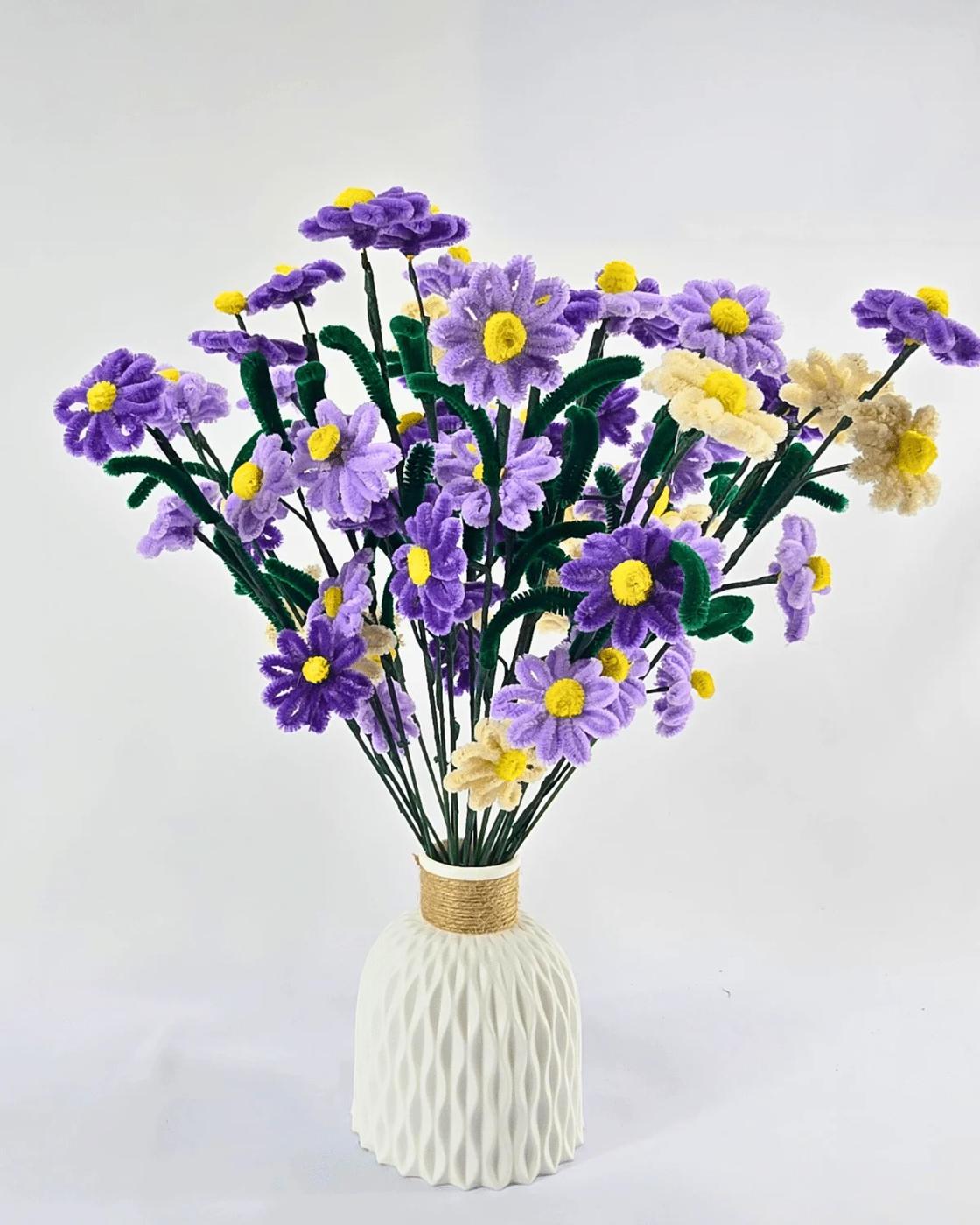 Cheerful pipe cleaner daisies with white petals and yellow centers, an easy spring craft made from chenille stems
