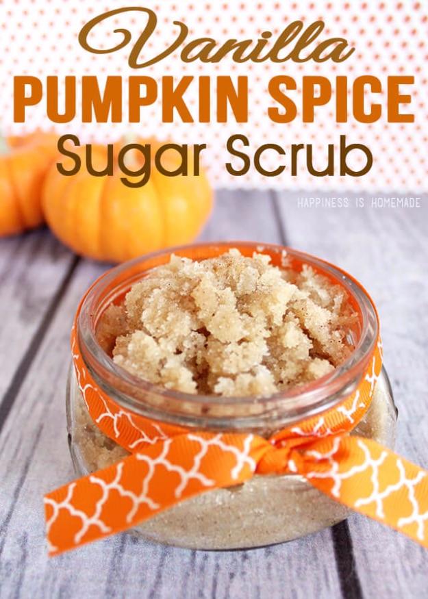 Vanilla pumpkin spice sugar scrub in a jar tied with orange ribbon, small pumpkins sitting behind it