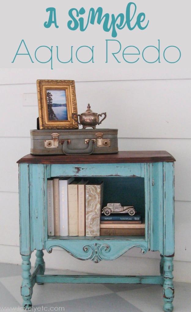 A Simple Aqua Redo graphic over a small aqua cabinet with heavily distressed edges and a warm stained wood top