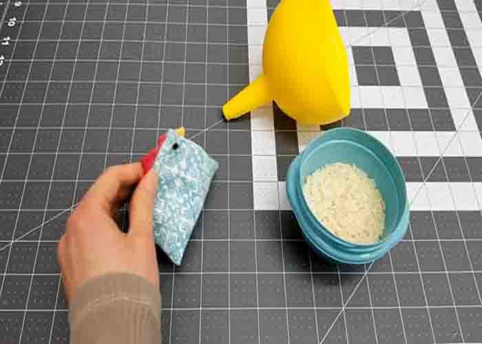 Stuffing the chicken pin cushion with rice