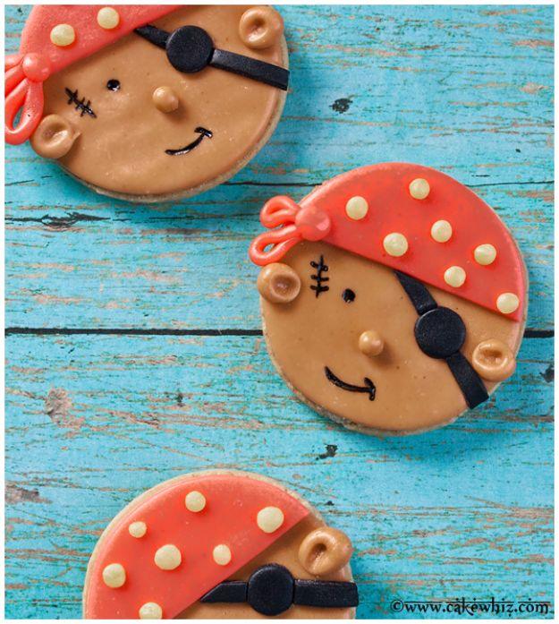 Pirate cookies made from round sugar cookies covered in brown, red and black marshmallow fondant faces