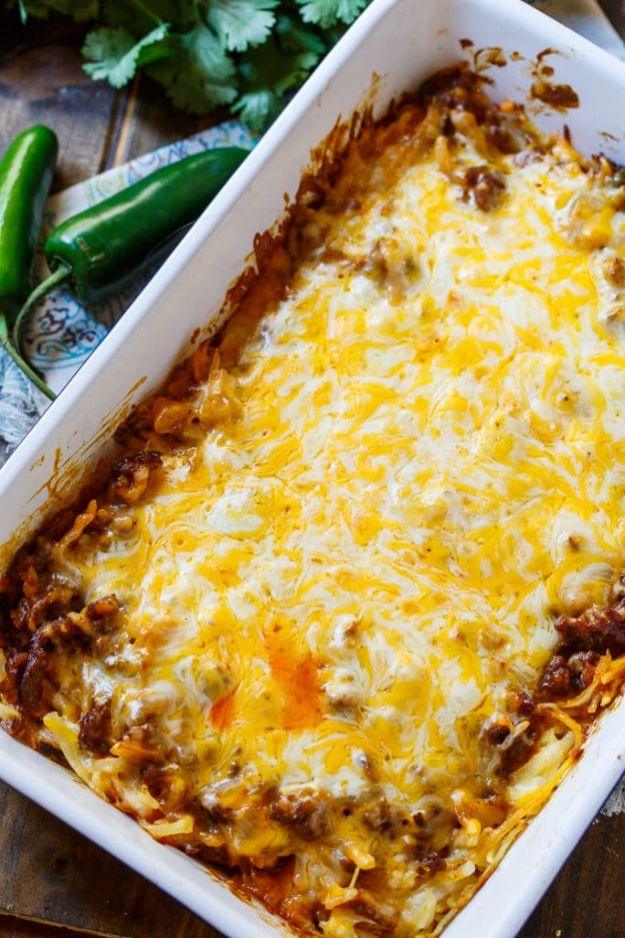 Chorizo hash brown casserole topped with melted Mexican cheese, enchilada sauce and a scatter of cilantro