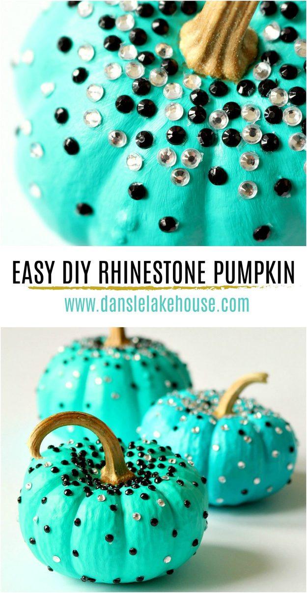 Bright turquoise mini pumpkins covered in black and clear stick on rhinestones, with natural gold stems