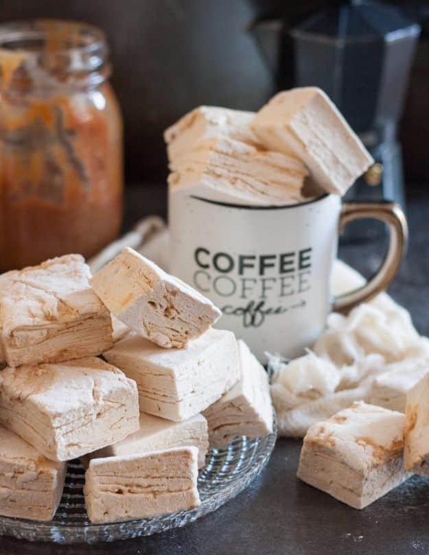 Caramel latte marshmallows, a pile of thick pale homemade marshmallow squares beside a white mug reading coffee