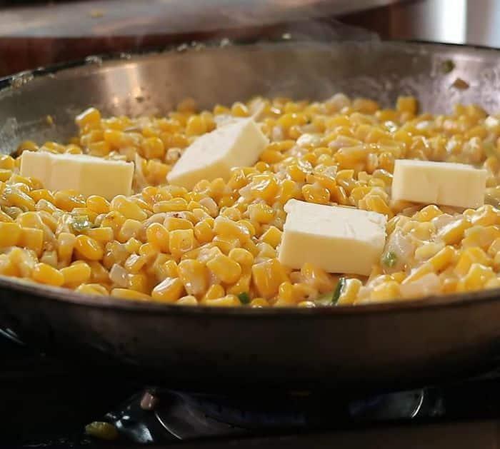 sauteed corn and vegetables with sliced butter on top