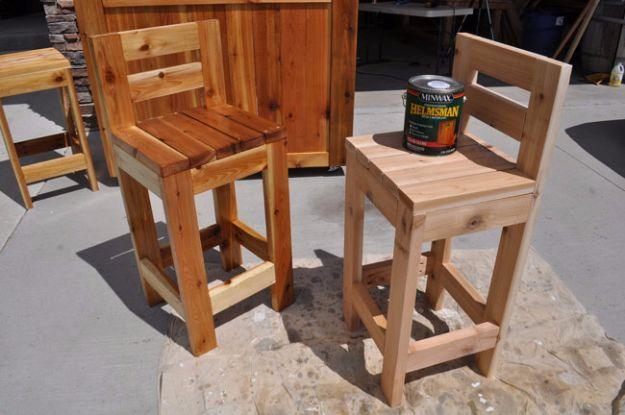 Easy wooden bar stools built from cedar with slatted seats and backs, in a garage beside a can of spar urethane