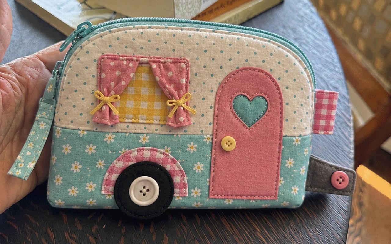 Free camper zipper pouch, a caravan shaped pouch in mint floral and pink with gingham curtains, a heart door and button wheel