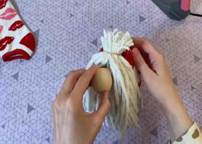 Attaching the nose of the DIY sock gnome