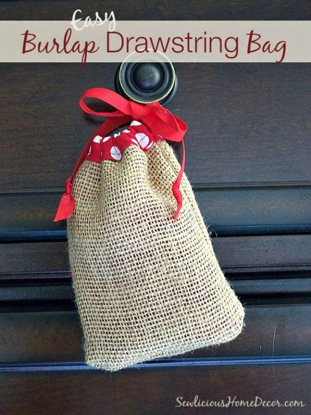 Burlap drawstring bags holding wine bottles and candles, tied with twine and lined in cotton, on a fall craft fair table