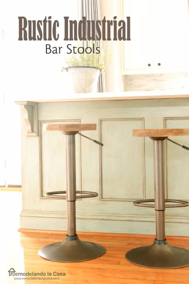 Rustic industrial bar stools with round stained wood seats and brown hammered metal bases at a painted kitchen island