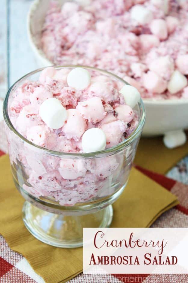 Cranberry ambrosia salad, pink and fluffy with mini marshmallows and crushed pineapple in a glass bowl