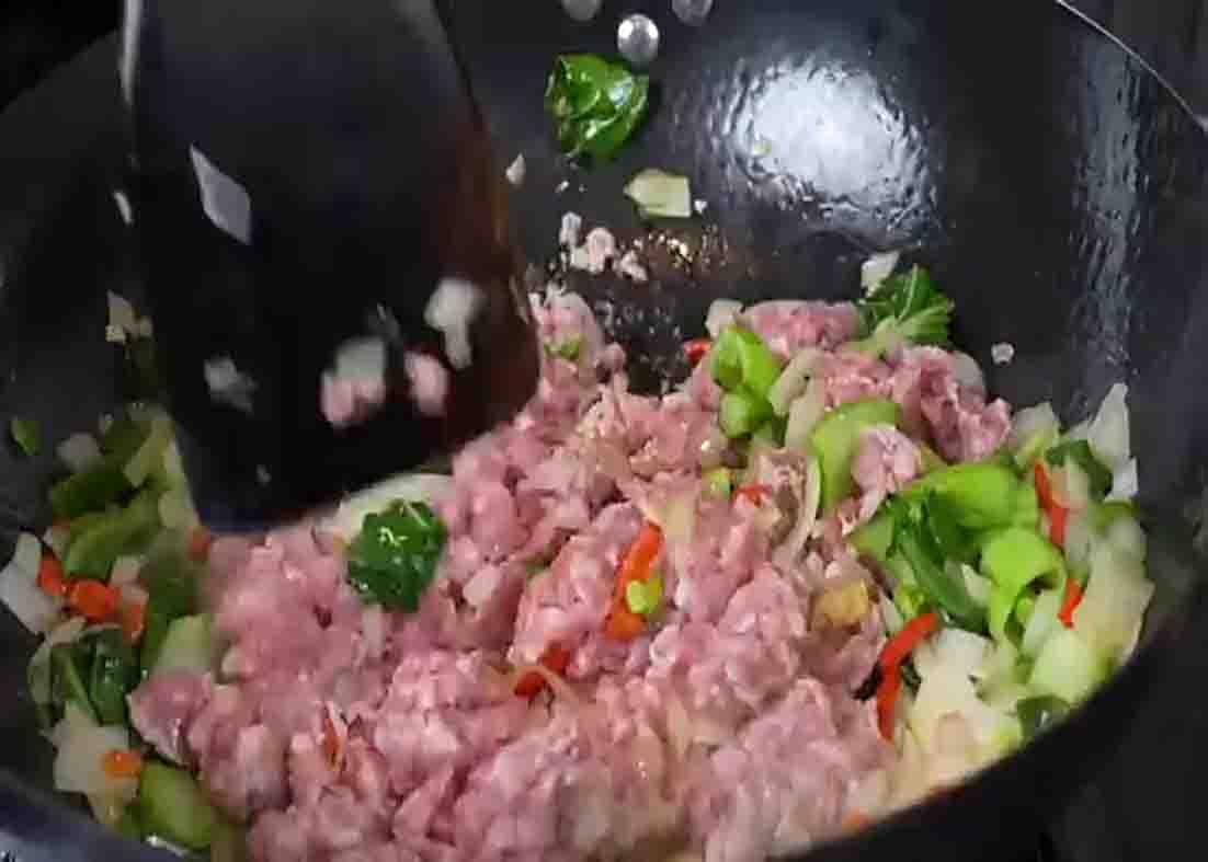 Sauteing the ingredients for the chili garlic noodles