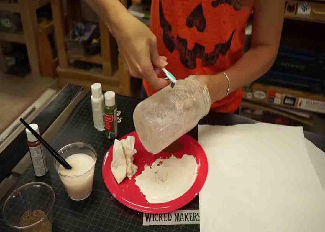Painting the mason jar for the Halloween hanging light