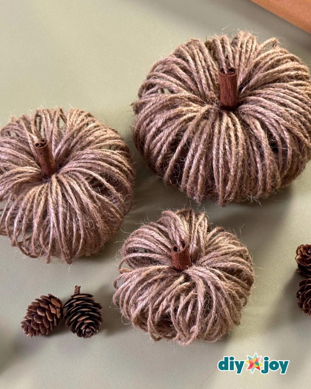 DIY fall decor - twine pumpkins with cinnamon stick stems in an easy fall centerpiece made from toilet paper rolls.