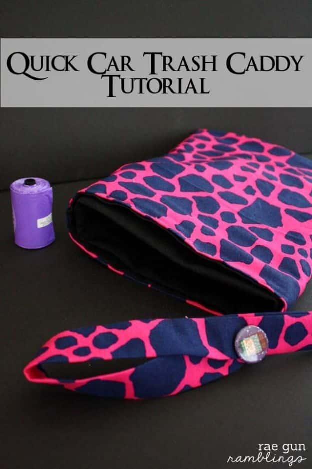 Travel trash caddy, a navy and hot pink giraffe print fabric bag with a button strap and a roll of purple liner bags