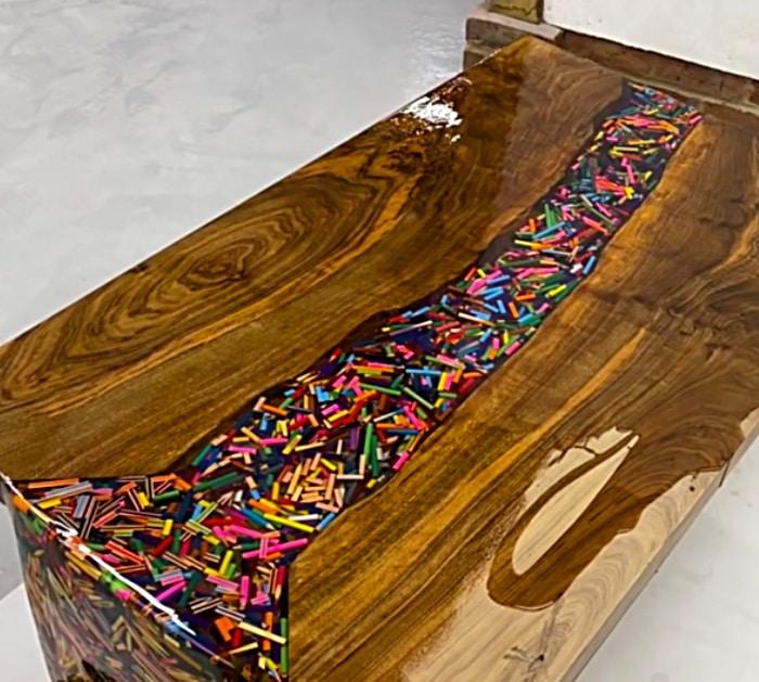 Make and epoxy and wood table with thousands of colored pencils