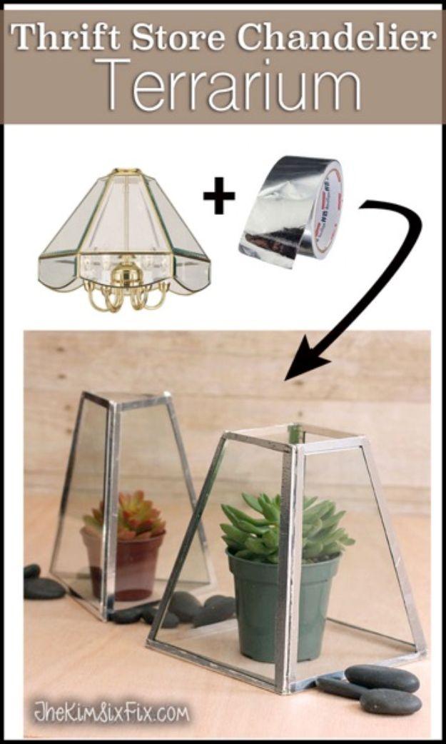 Chandelier to terrarium, two geometric glass terrariums made from silver taped panels holding potted succulents and rocks