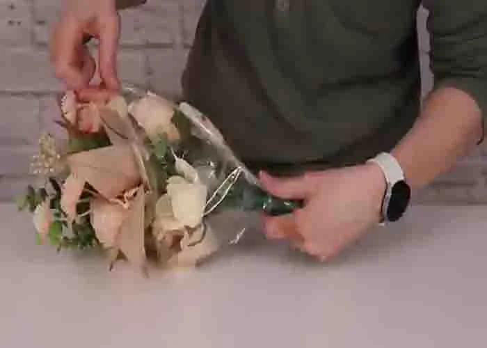 Inserting the flower bouquet inside the bubble balloon