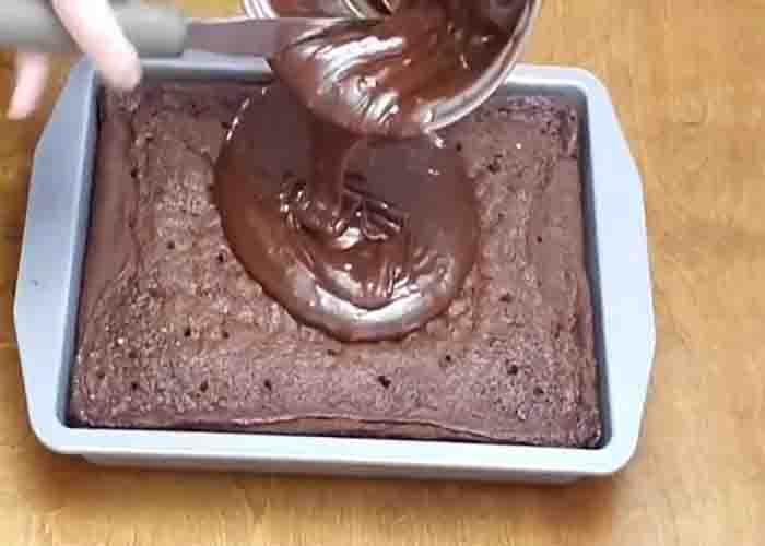 Pouring the chocolate ganache over the Hershey's chocolate cake