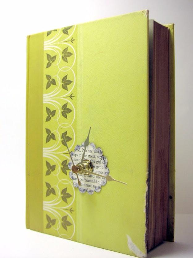 Old book clock made from a chartreuse hardcover standing on end with gold hands on a small book page dial
