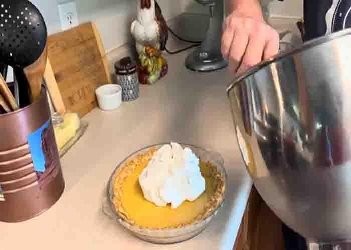 Adding the whipped cream on top of the atlantic beach pie