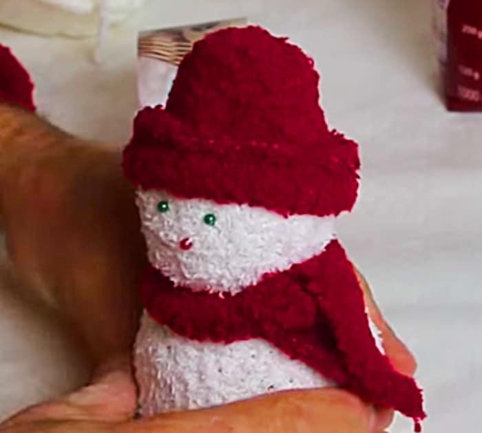 Learn to make this quick easy cheap DIY sock snowman with socks and rice
