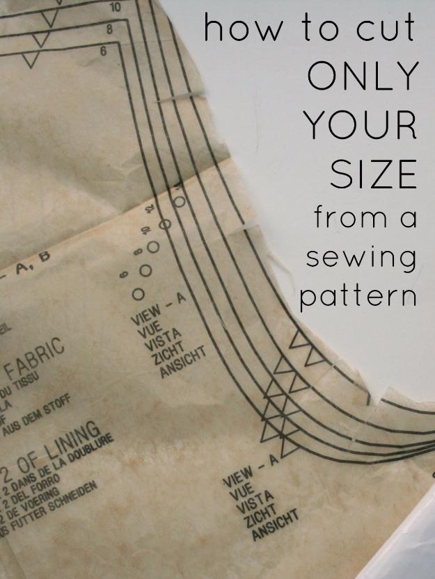Sewing pattern tissue folded along a printed size line, under text reading how to cut only your size