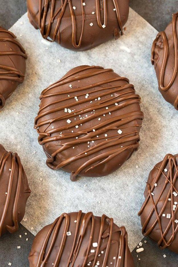 4 ingredient paleo vegan chocolate coconut cookies, chocolate coated rounds drizzled and salted on parchment