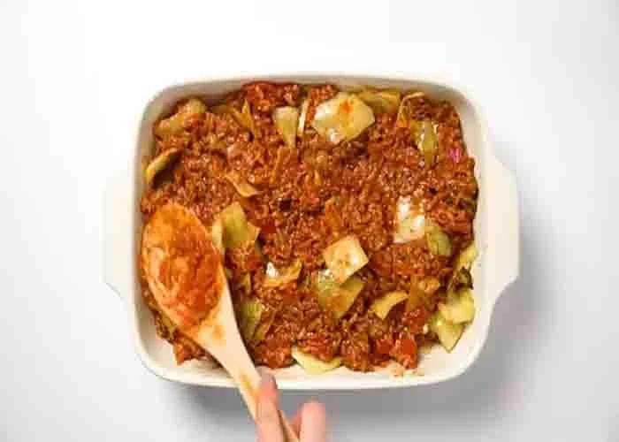 Assembling the ground beef and cabbage casserole