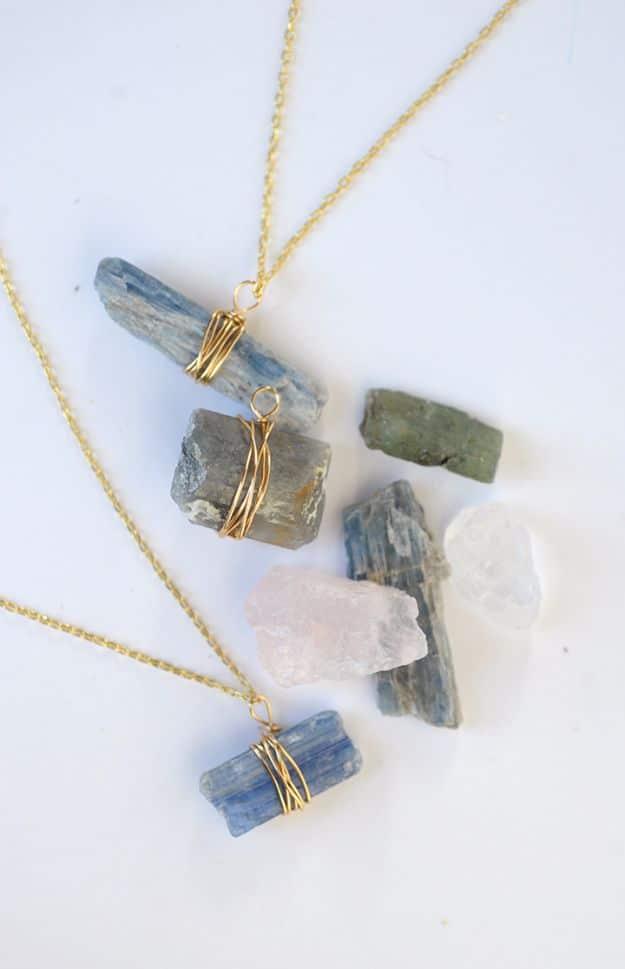 DIY wire wrapped stone necklace, raw blue kyanite and pale quartz pieces wrapped in gold wire on fine gold chains