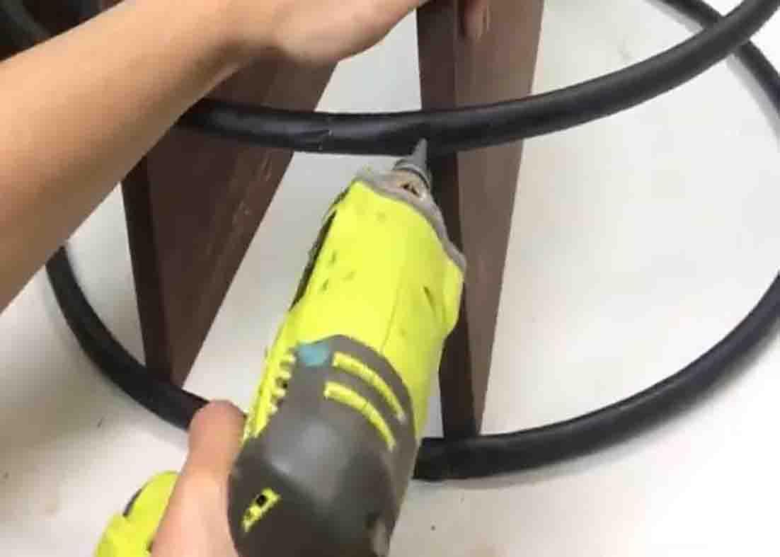 Attaching the second hula hoop to complete the DIY shelf