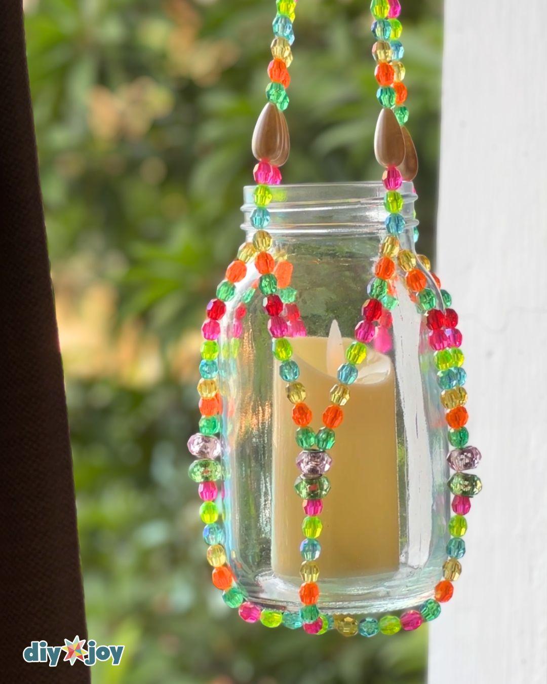 A beaded lantern close up, showing large glass spacer beads separating runs of smaller beads on each pair of strands