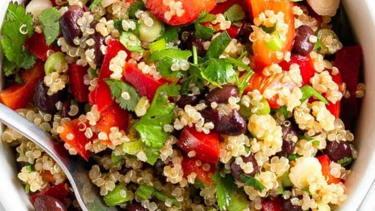 Black bean and quinoa salad with red bell pepper, green onion and cilantro tossed in a lime cumin dressing