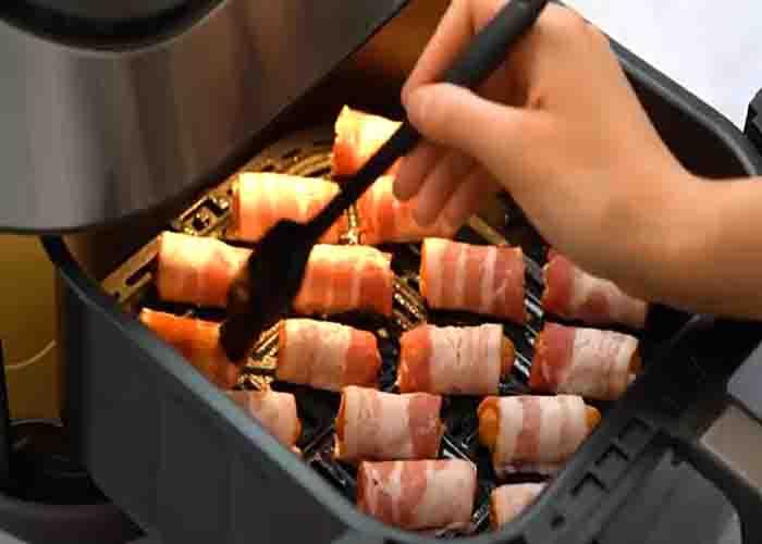Brushing the lil smokie with BBQ sauce