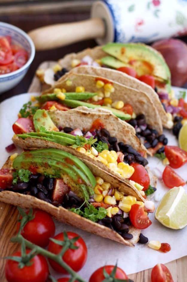Five minute vegan tacos with tempeh, corn salsa and avocado in corn tortillas on a plate for a fast dinner