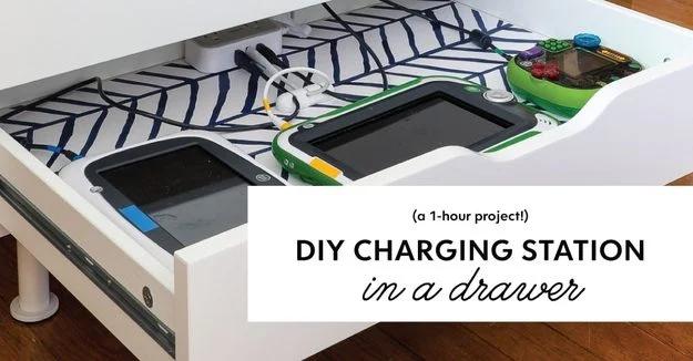 Open drawer lined with patterned paper holding tablets and cords, labeled DIY charging station in a drawer