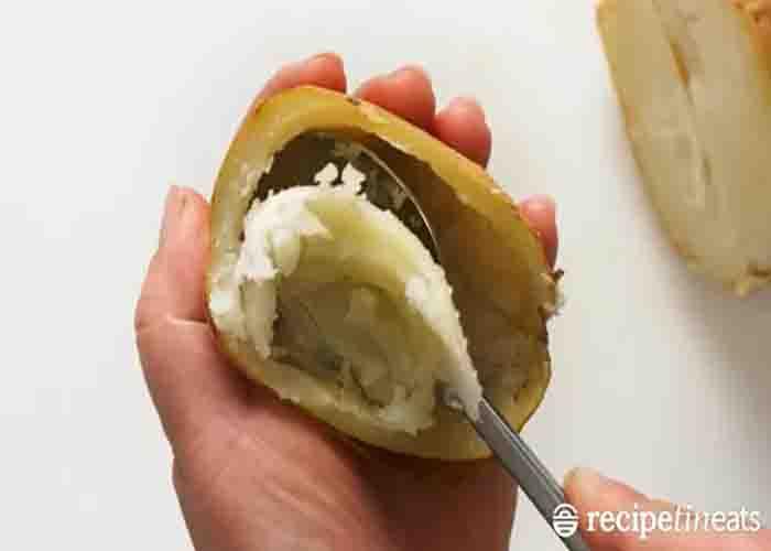 Scraping the insides of the baked potato