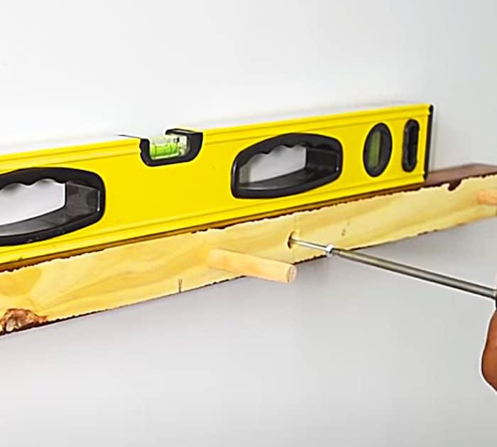 Make a floating shelf from a 2 x 4 and dowel