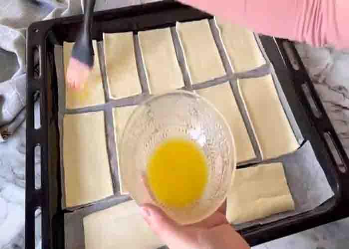 Brushing some melted oil to the puff pastry