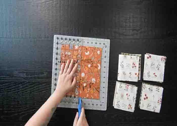Cutting the layer cake to make charm pack squares