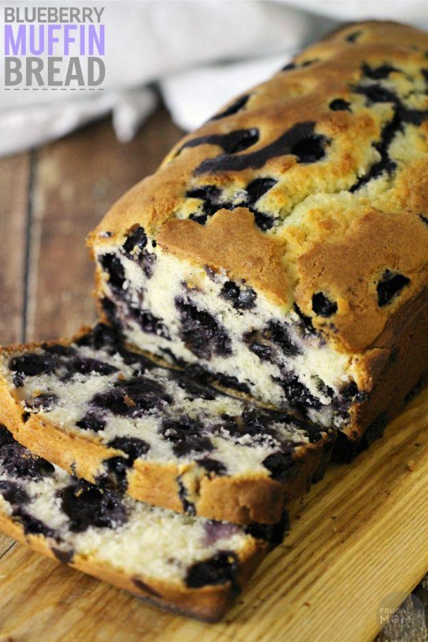 Blueberry muffin bread sliced on a wooden board with dark berries through the crumb and a title overlay
