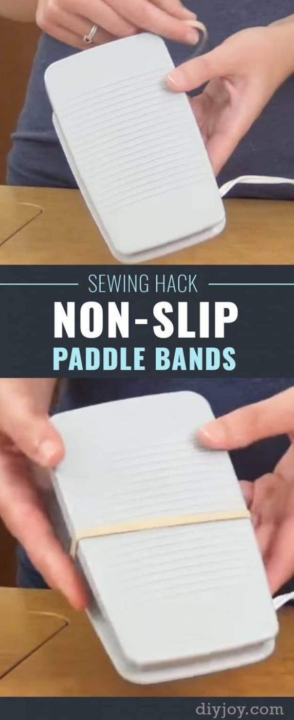 Rubber band sewing hack, two hands stretching a rubber band around the underside of a white sewing machine foot pedal