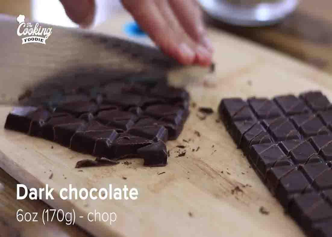 Chopping the dark chocolate for the chocolate oatmeal cake recipe