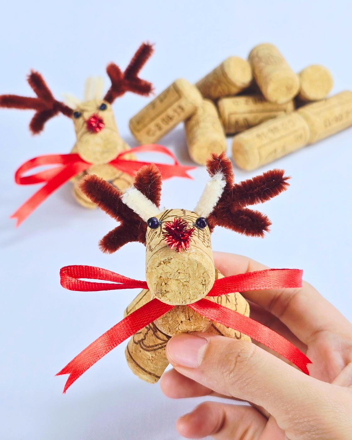 Easy Crafts - two finished cork reindeer with a pile of loose wine corks blurred in the background