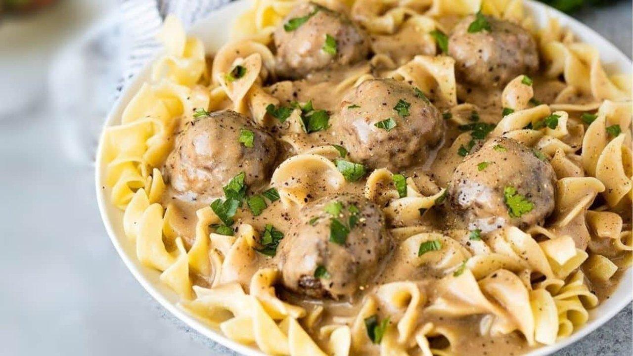 Swedish meatballs in a creamy sour cream gravy served over buttered egg noodles with chopped parsley
