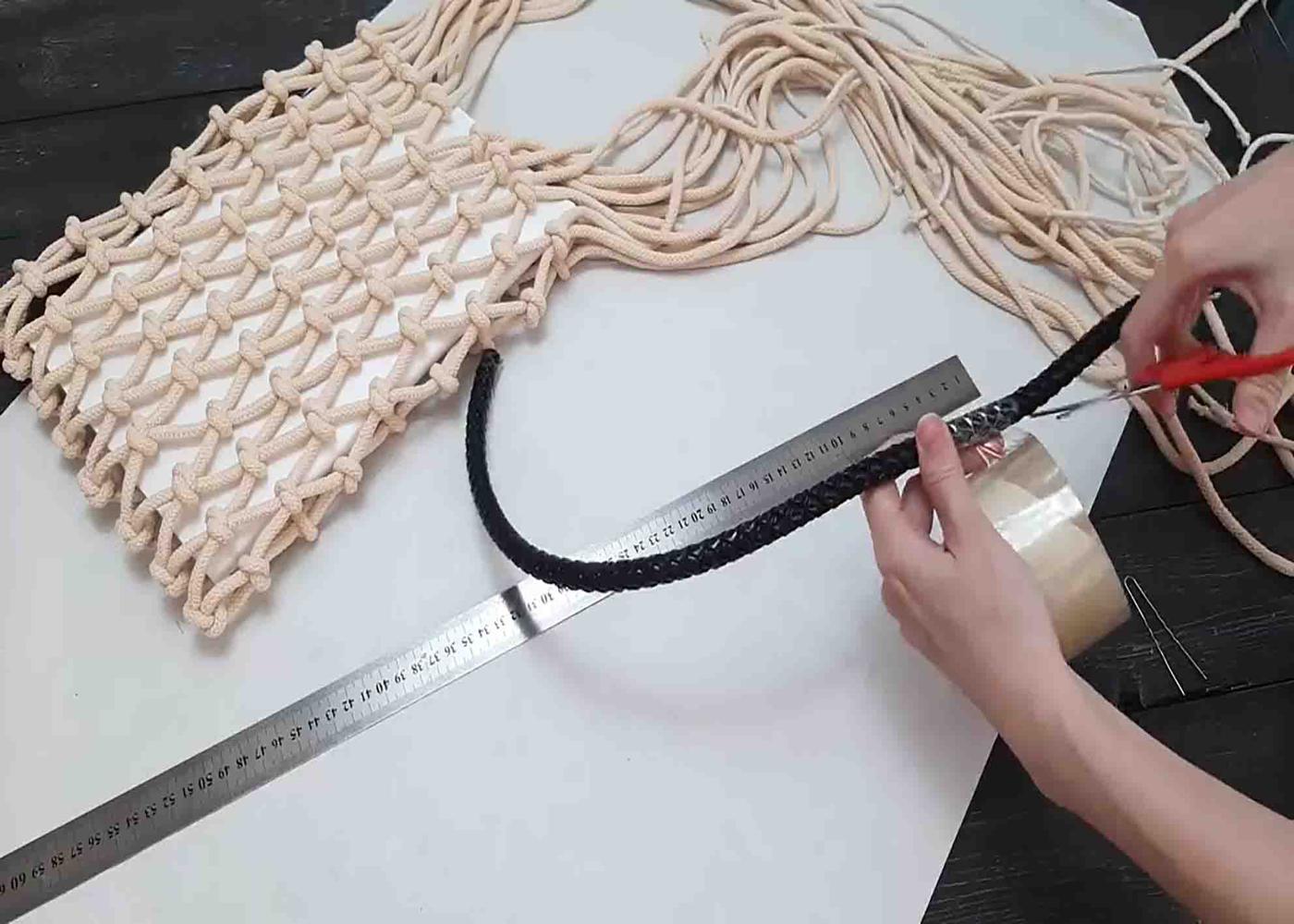 Attaching the handles of the prada macrame tote bag